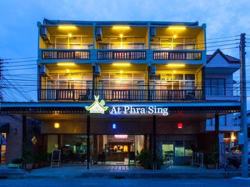 At Phra Sing Guest House frontage and illuminated balconies at dusk