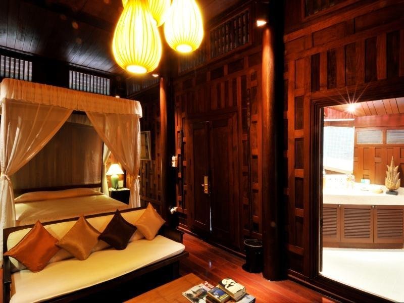Four-poster bed and carved timber interior at Chakrabongse Villas