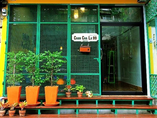 Green entrance and potted plants at Chan Cha La 99 Hostel