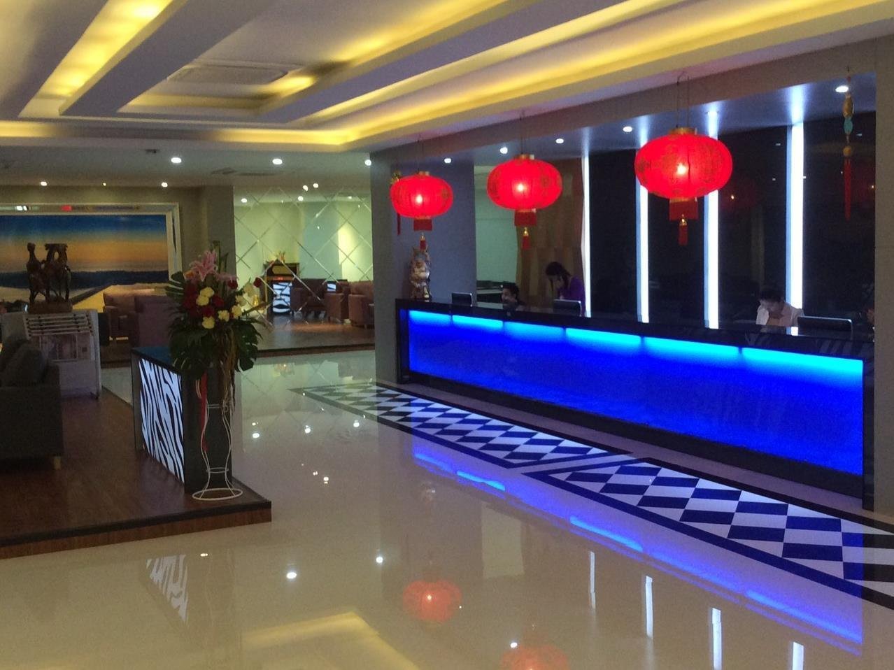 Grand Pink reception counter illuminated in blue beneath red lanterns