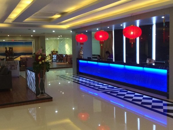 Grand Pink reception counter illuminated in blue beneath red lanterns