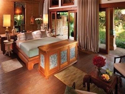 Timber bedroom with garden doors at Howie’s HomeStay