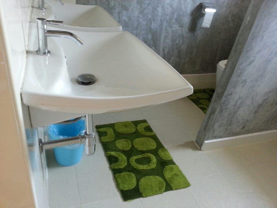 White washbasin and shower area at Khanom Garden Suite