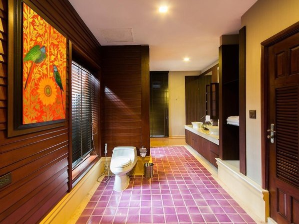 Bathroom with wood panelling and a long double vanity at Sireeampan