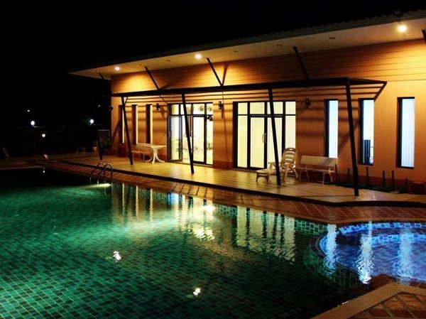 Pool and building at Triple P Home at night